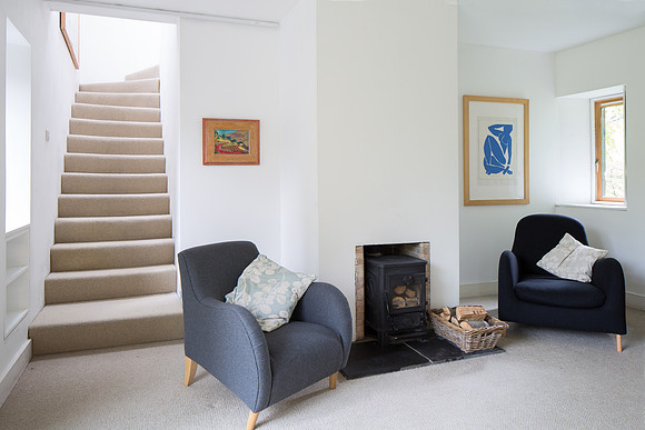 Fireplace in the snug with awindow to the botanical gardens