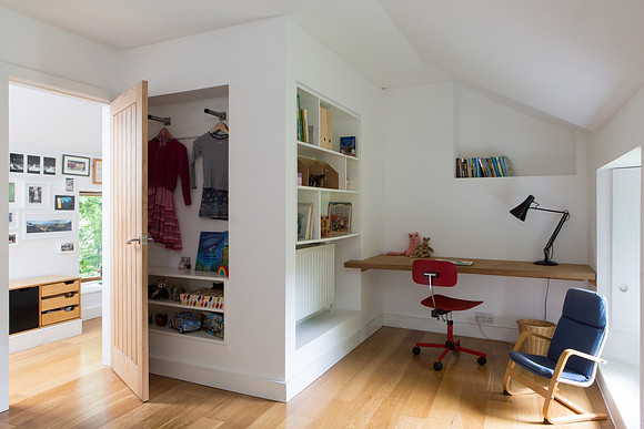 Childs bedroom study area, with recessed shelving and clothes hangers